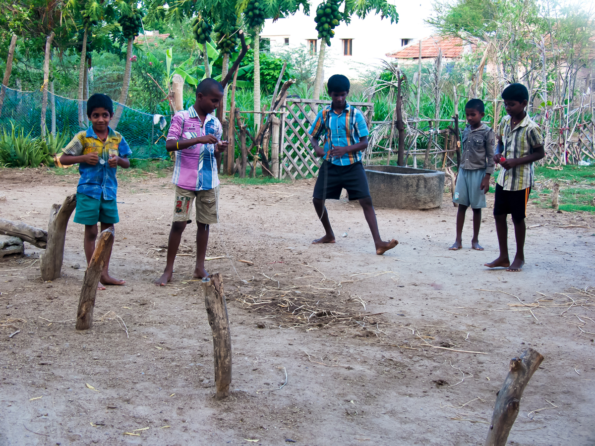 Boys at the children's home spinning tops.